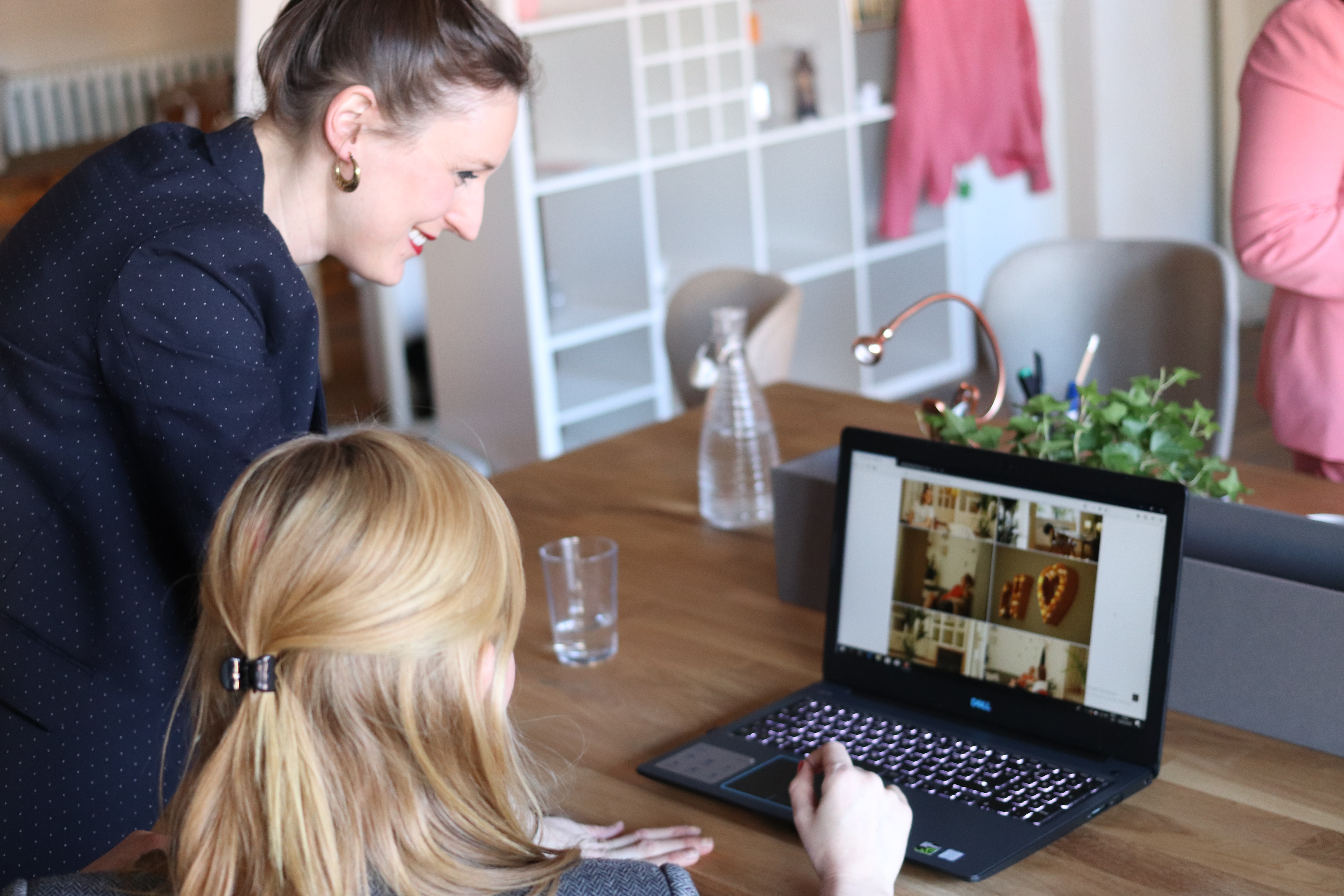 Two women looking at a laptop