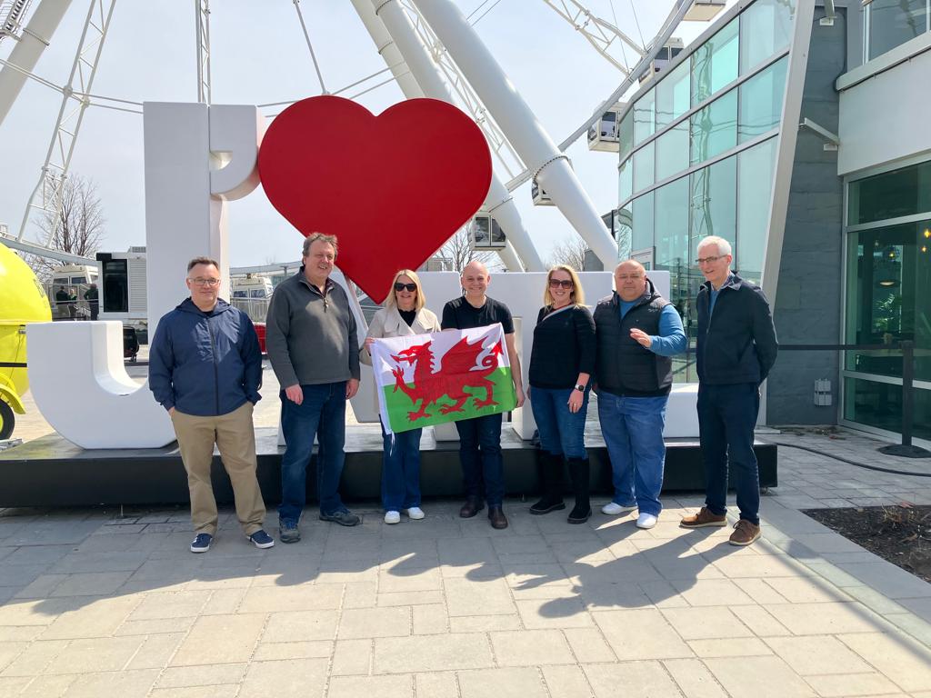 Principals and Vice-Principals holding up the Welsh flag in Montreal