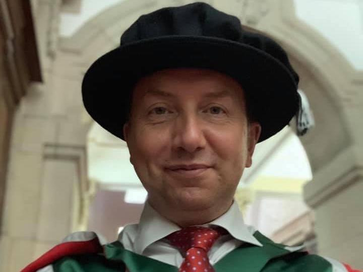 Rhys Jones in graduation robes