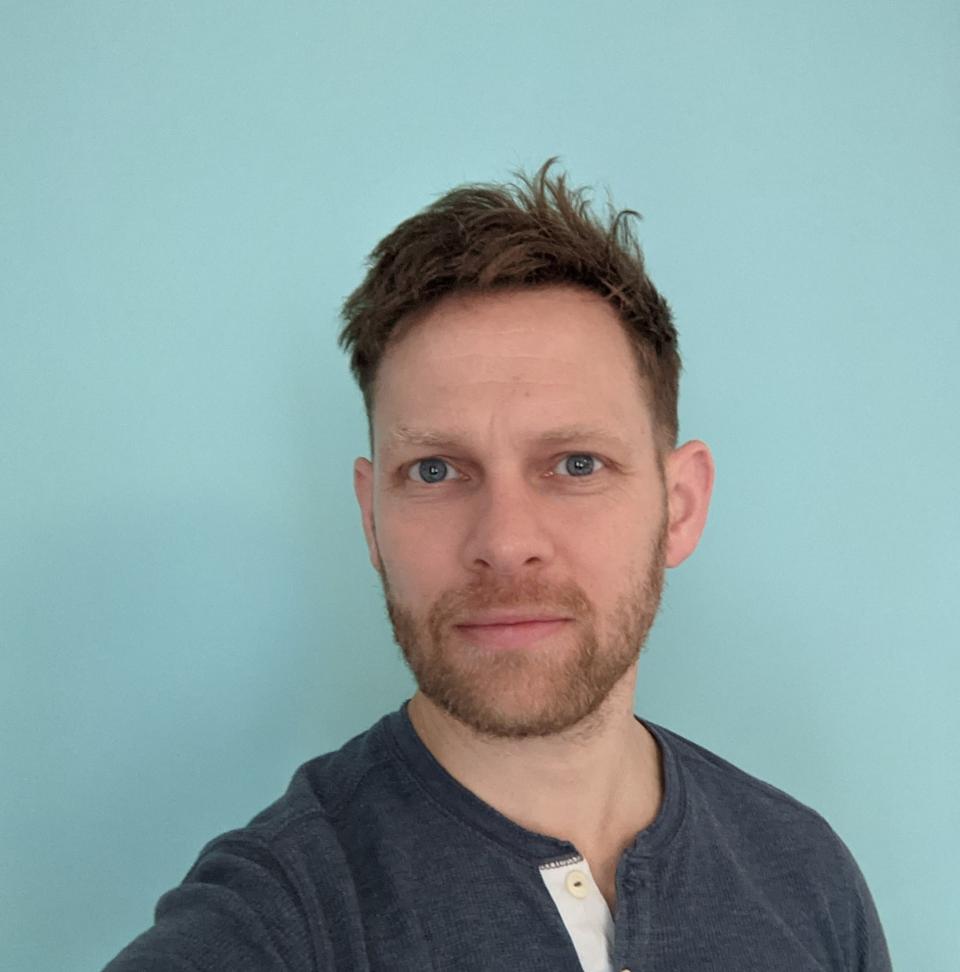 Photograph of Bill Burson against a blue background
