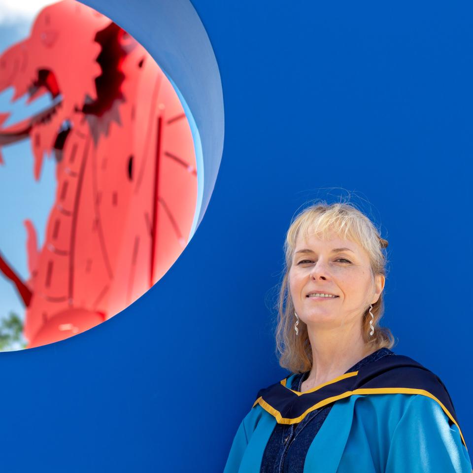 Photo of Beck Collett in graduation gown