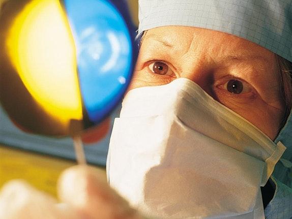 Technician holding a wafer in cleanroom close up