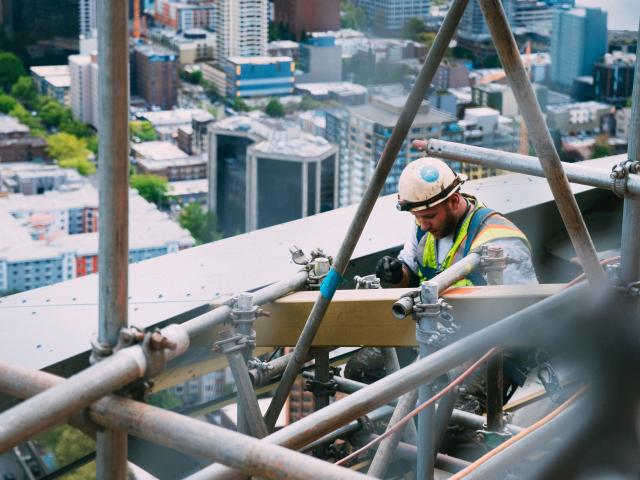 A builder working on a scaffold
