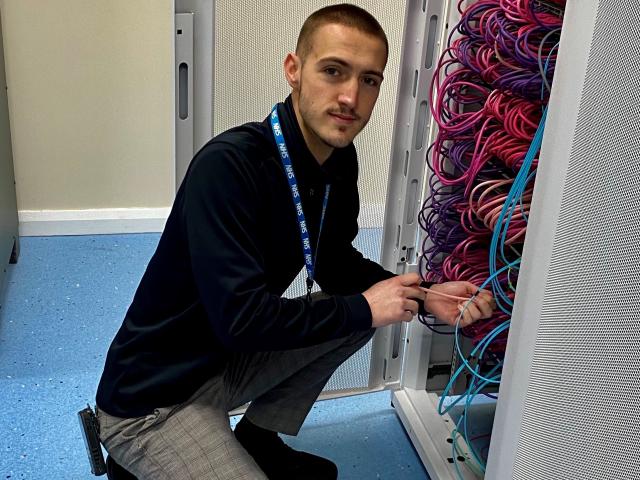 Photo of Sam Jackson working on a server