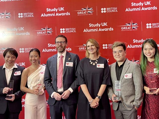 StudyUK Alumni award winners holding their awards. 