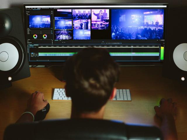 A person working at a bank of screens
