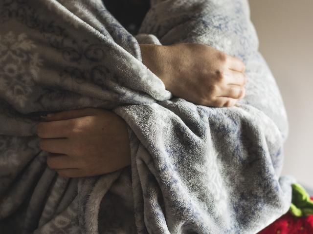 Person wrapped in a warm blanket