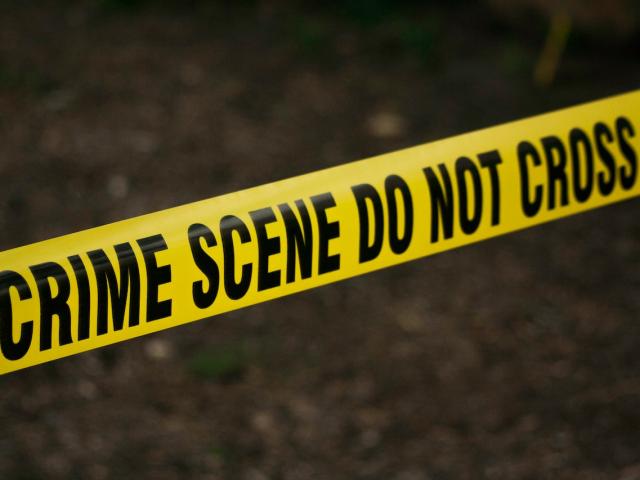 Yellow police tape saying 'crime scene do not cross'