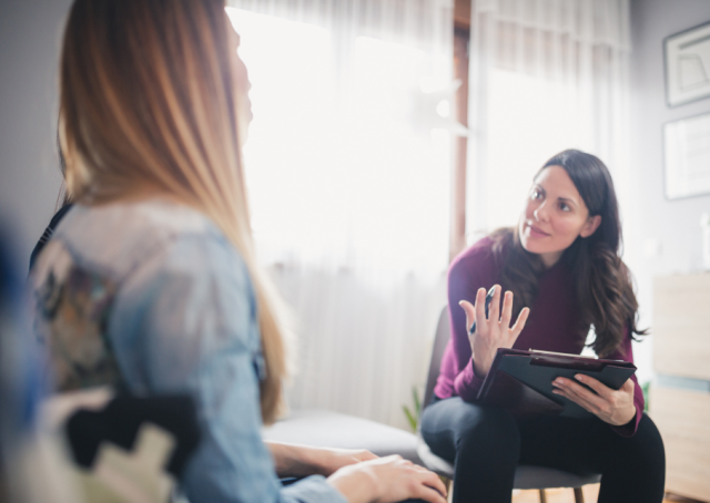 A young woman talking to a counsellor