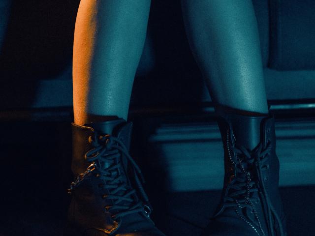 Close up of a woman's legs wearing black ankle boots