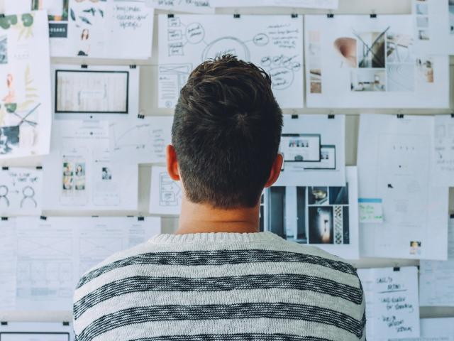 Man looking at project wall