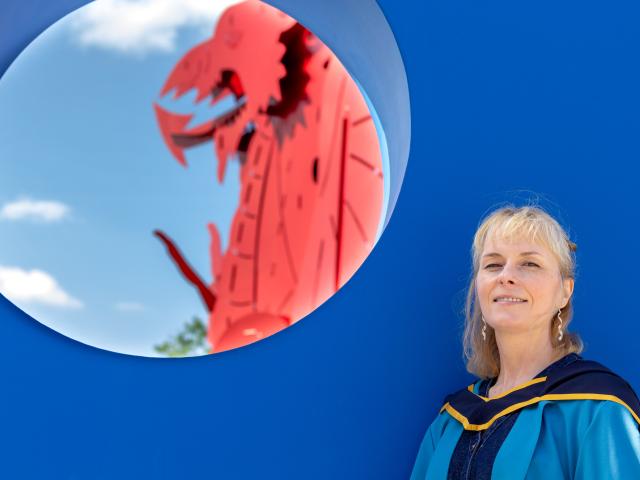 Photo of Beck Collett in graduation gown