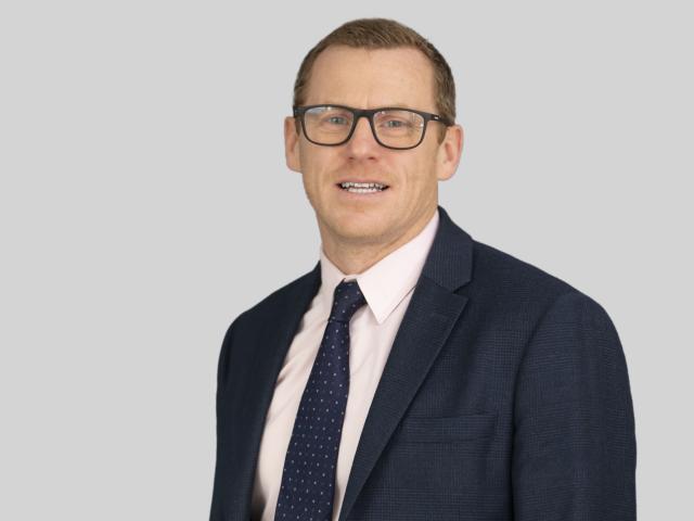 Photo of James Owen against a grey background
